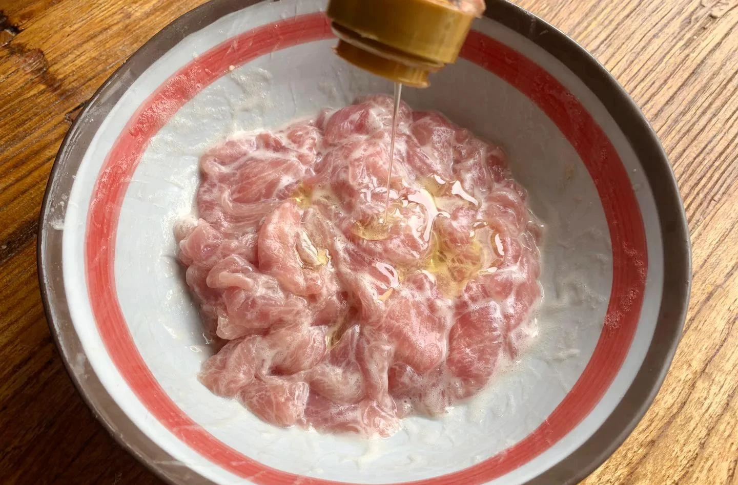Velveted chicken slices coated and passed through warm oil, silky and ready for the wok