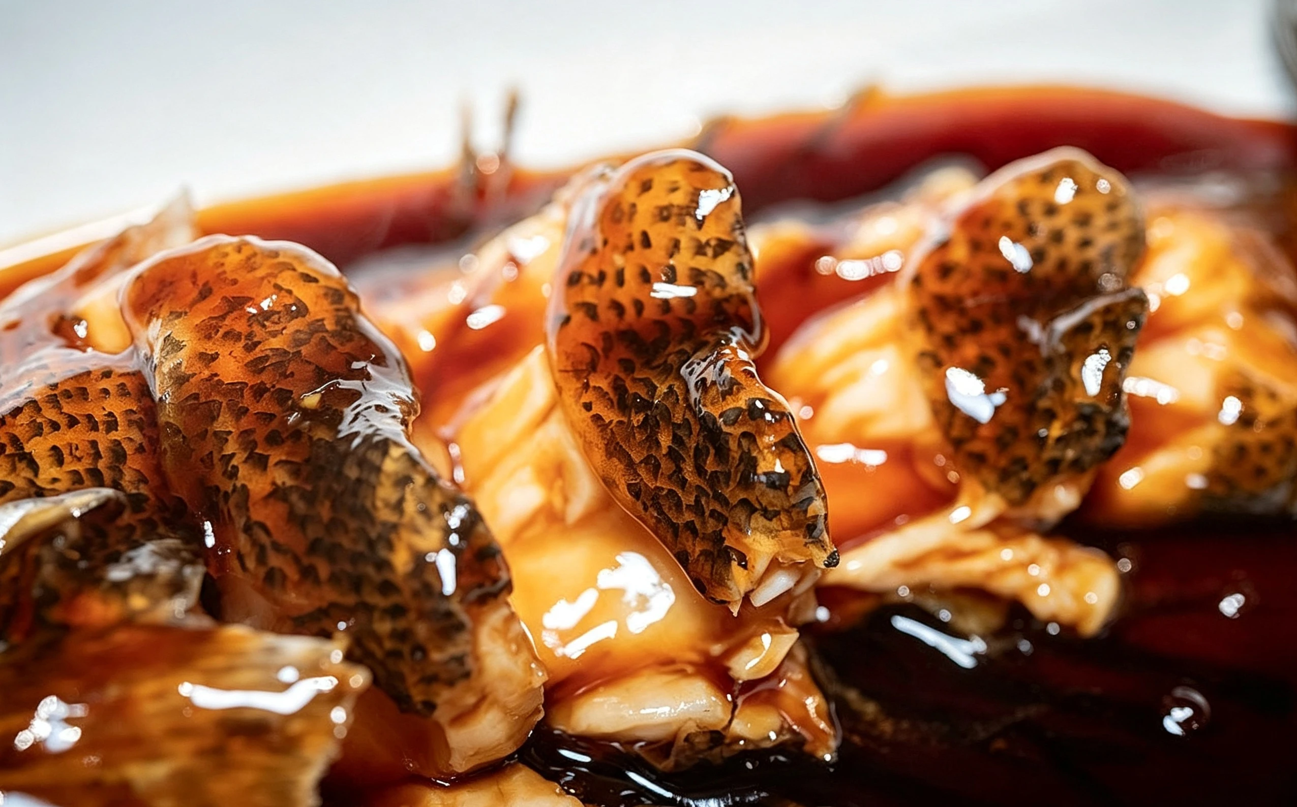 Close-up of West Lake fish, steamed whole under a sweet-sour vinegar sauce